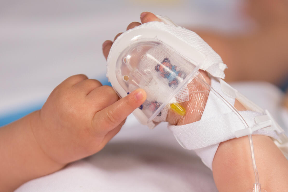 330L I.V. House UltraDressing on infant's hand