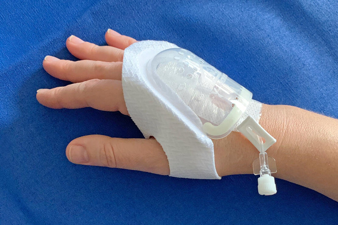 730M I.V. House UltraDressing protects I.V. insertion site on adult's hand